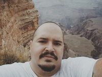 Standing on a cliff at the Grand Canyon.
