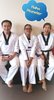 My Masters in Tae Kwon Do (Master Park & His Wife Master Lee) I am in the middle. Master Lee is laughing at me because my umma (mom) called me a Monster.